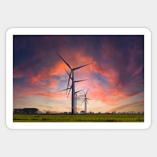 Windmill farm on green meadow under moody red sky Sticker